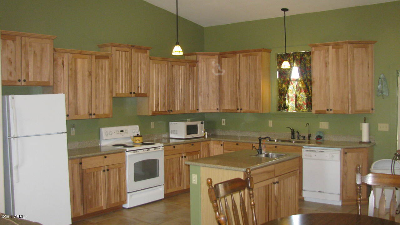 4126 North Colt Road Apache Junction, AZ 85119 - Photo 3 of 18 a kitchen with a sink a stove a refrigerator and cabinets