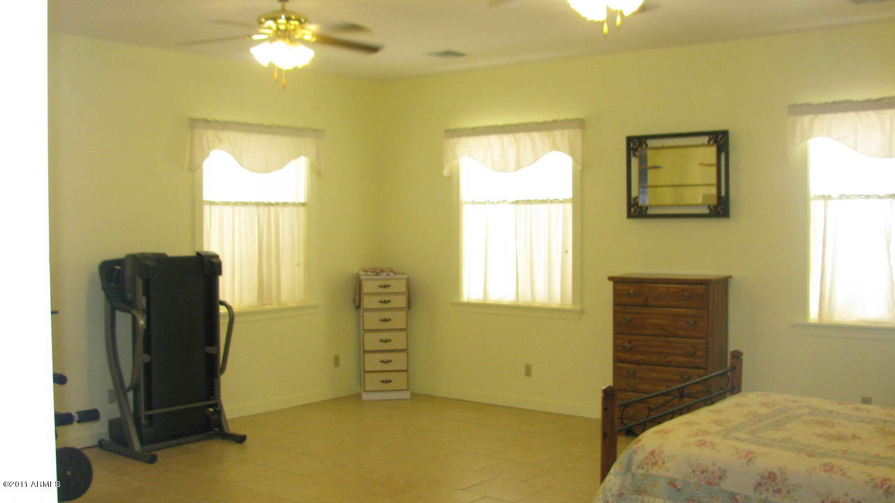 4126 North Colt Road Apache Junction, AZ 85119 - Photo 9 of 18 a bedroom with a bed and a window