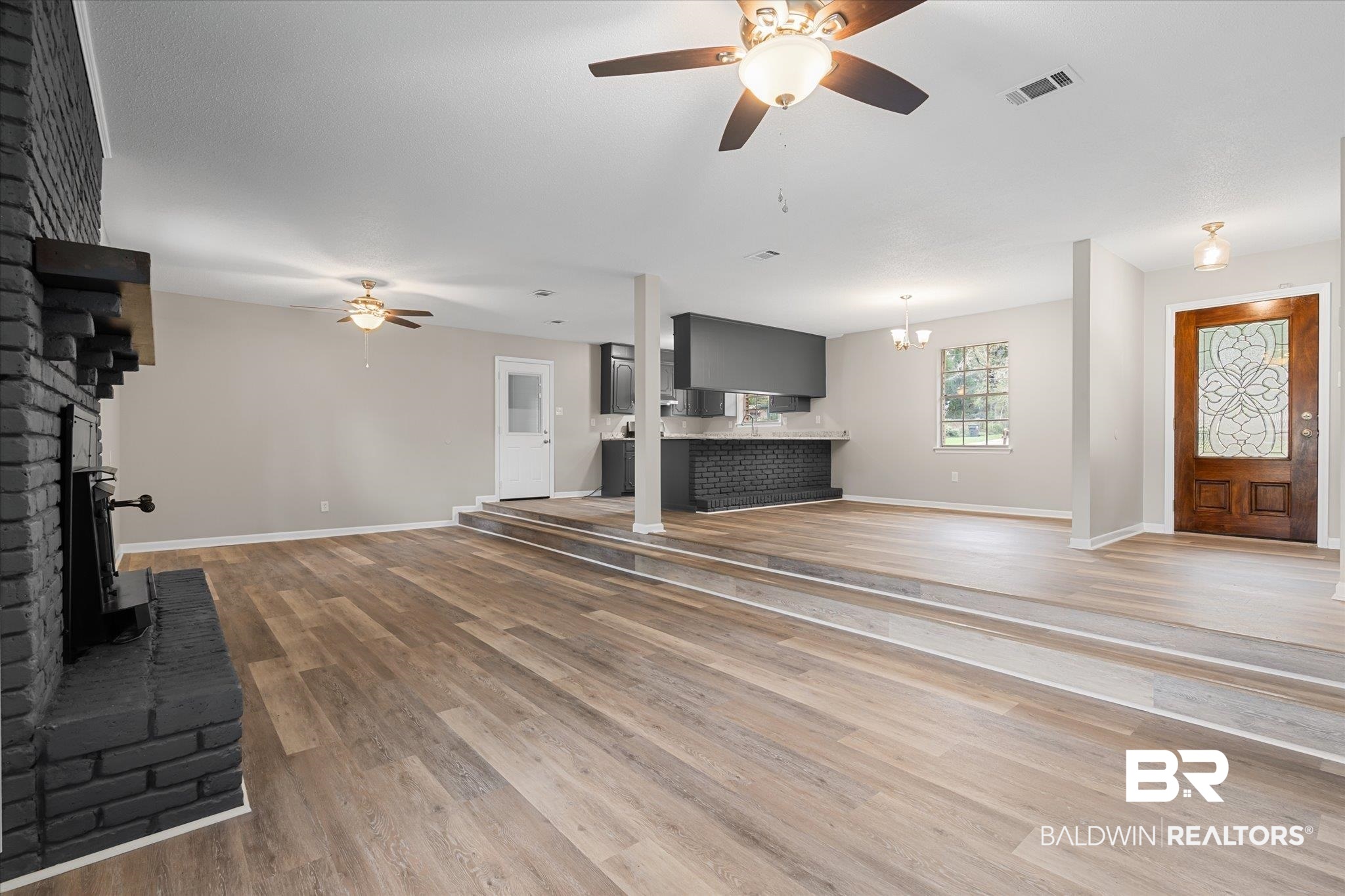 5015 Golfway Drive Eight Mile, AL 36613 - Photo 11 of 31 Unfurnished living room with ceiling fan, a fireplace, and light wood-type flooring