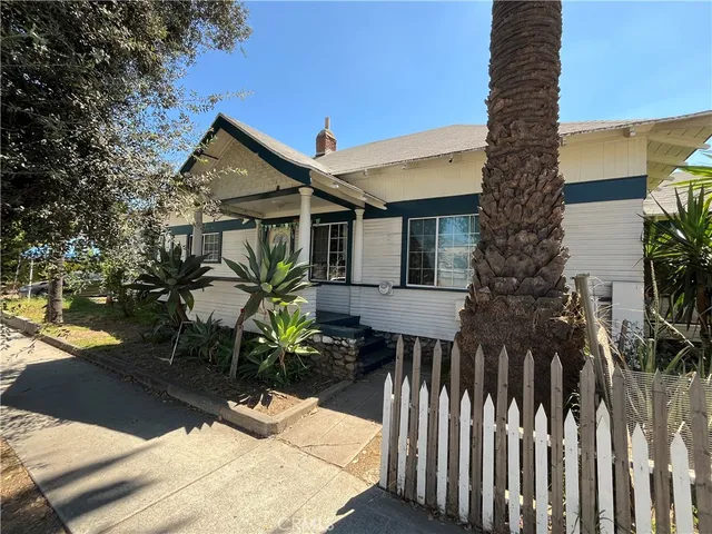 a front view of house with a garden