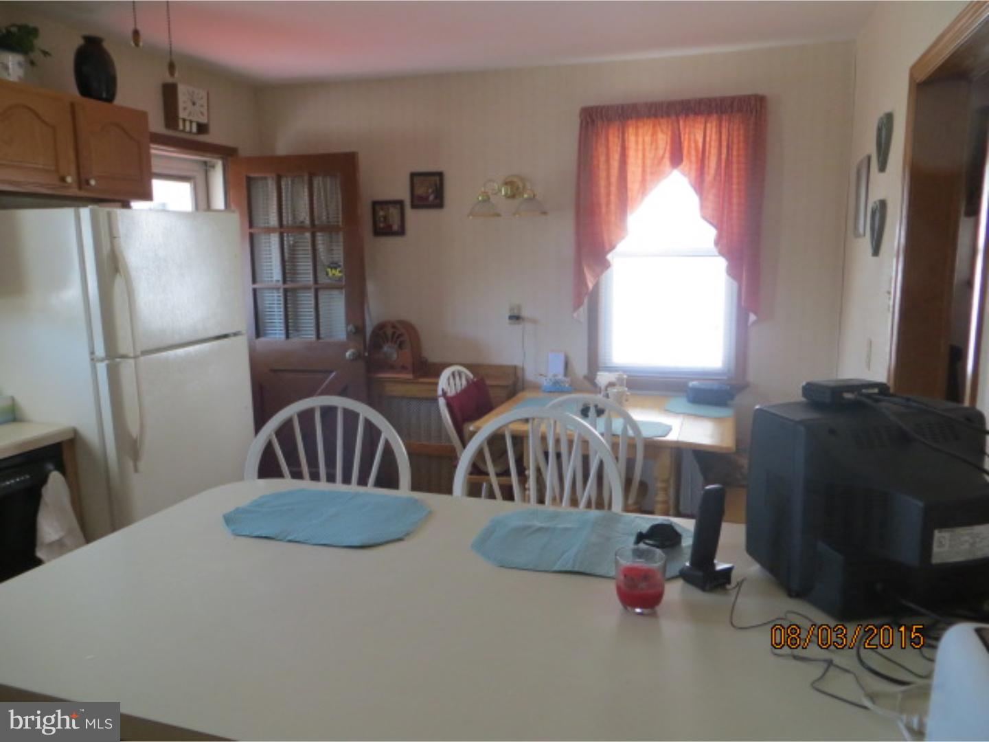 237 Powell Road Springfield, PA 19064 - Photo 17 of 25 a kitchen with furniture a refrigerator and a window