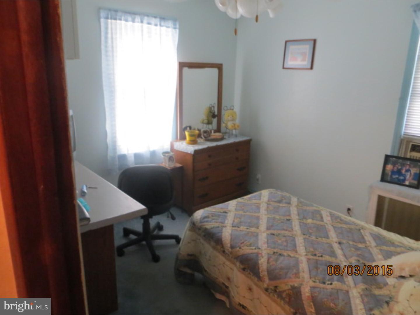 237 Powell Road Springfield, PA 19064 - Photo 19 of 25 a bedroom with a bed and a table in it