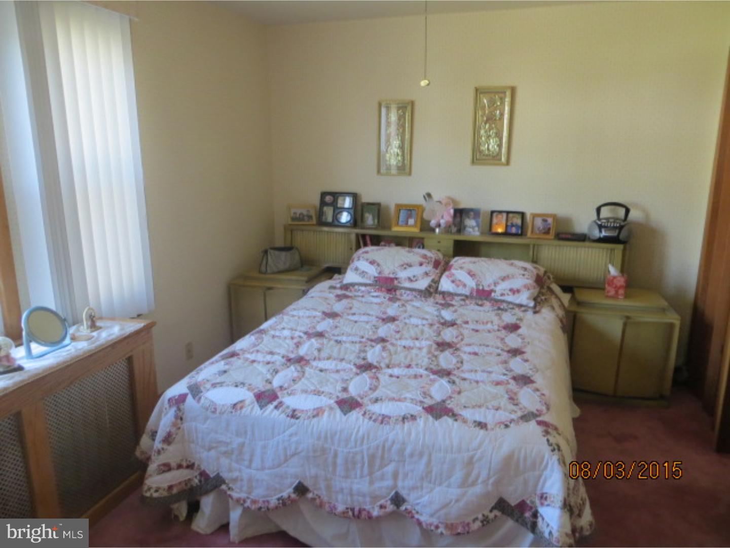 237 Powell Road Springfield, PA 19064 - Photo 20 of 25 a bed sitting in a bedroom next to a window
