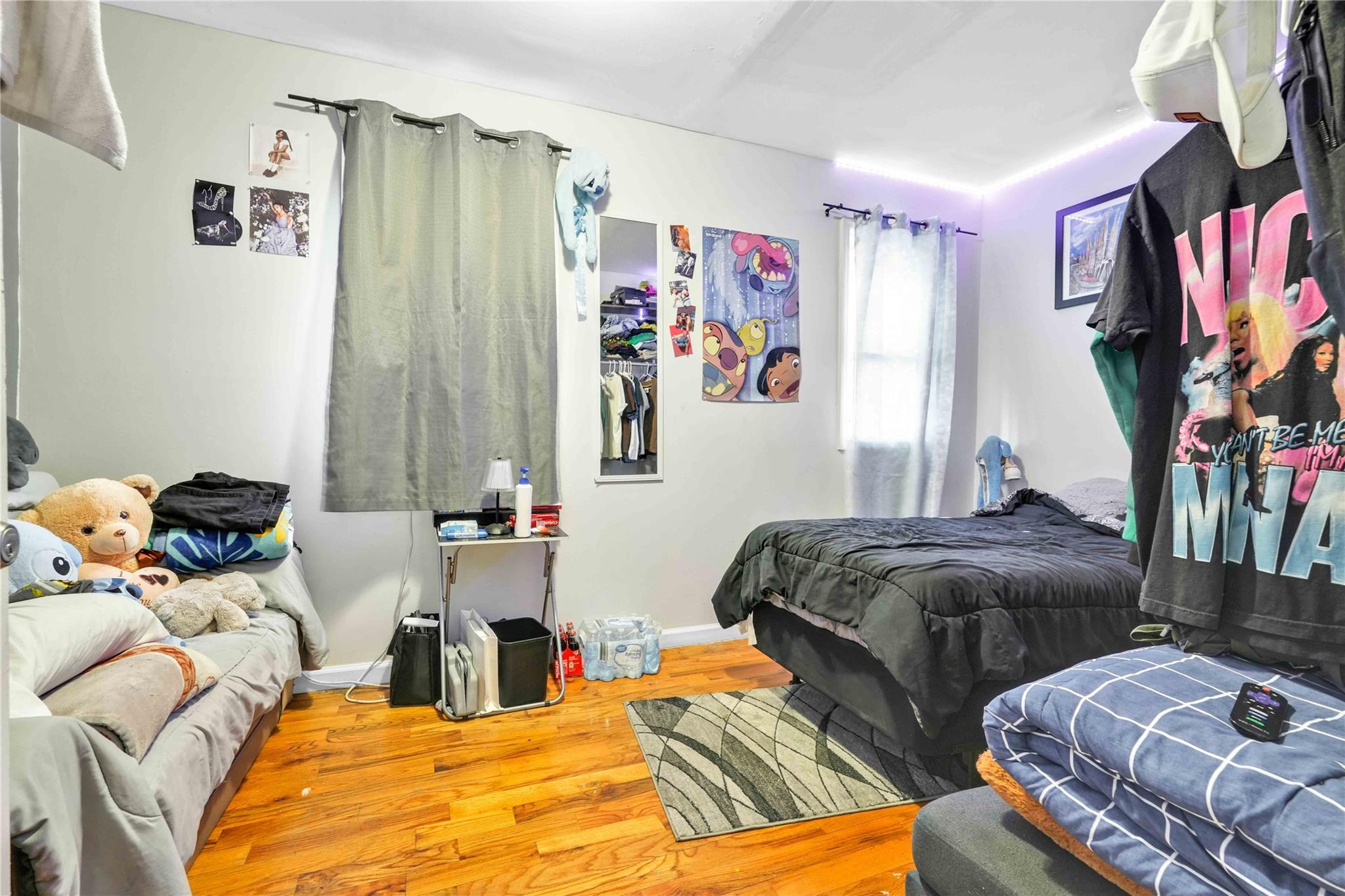 109-55 Lefferts Boulevard Queens, NY 11420 - Photo 12 of 21 a bedroom with two beds and a painting on the wall