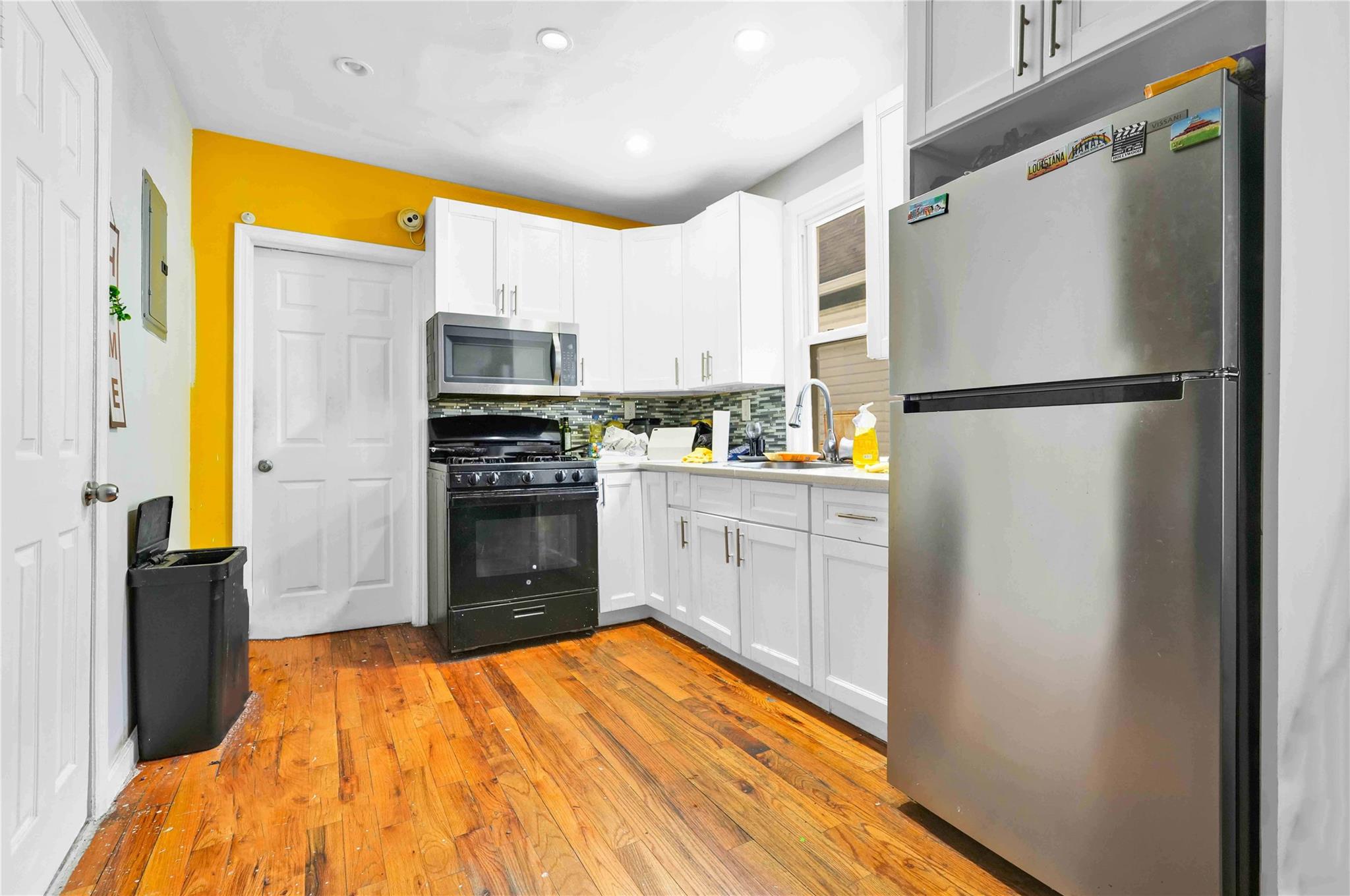109-55 Lefferts Boulevard Queens, NY 11420 - Photo 14 of 21 a kitchen with a refrigerator and a stove
