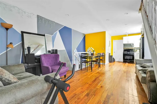 a living room with furniture and floor to ceiling windows