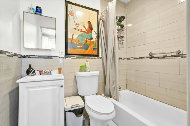 a white toilet sitting next to a bathroom sink