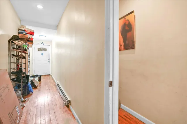 a view of a hallway with wooden floor and stairs