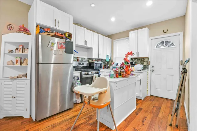 a white refrigerator freezer sitting inside of a kitchen