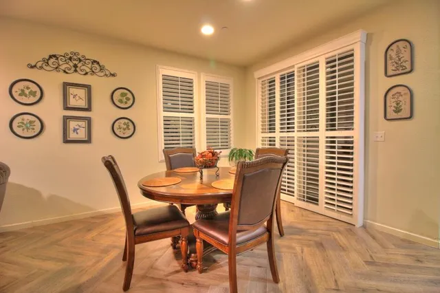 a view of a dining room with furniture and window