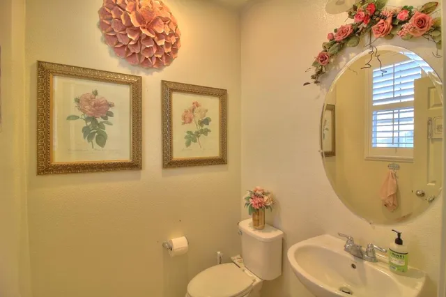 a bathroom with a sink mirror and vanity
