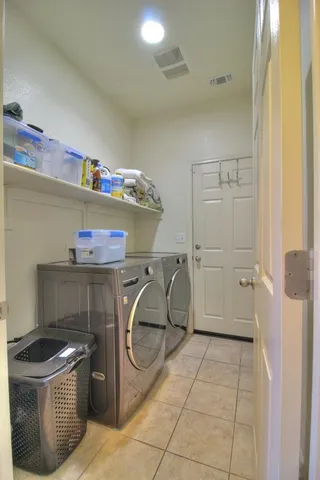 a utility room with cabinets dryer and washer