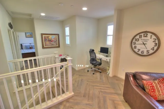 a view of a hallway with seating area