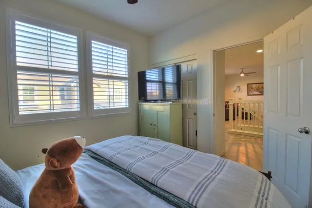 a bedroom with a bed and windows