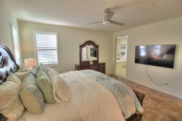 a bedroom with a bed and a flat screen tv