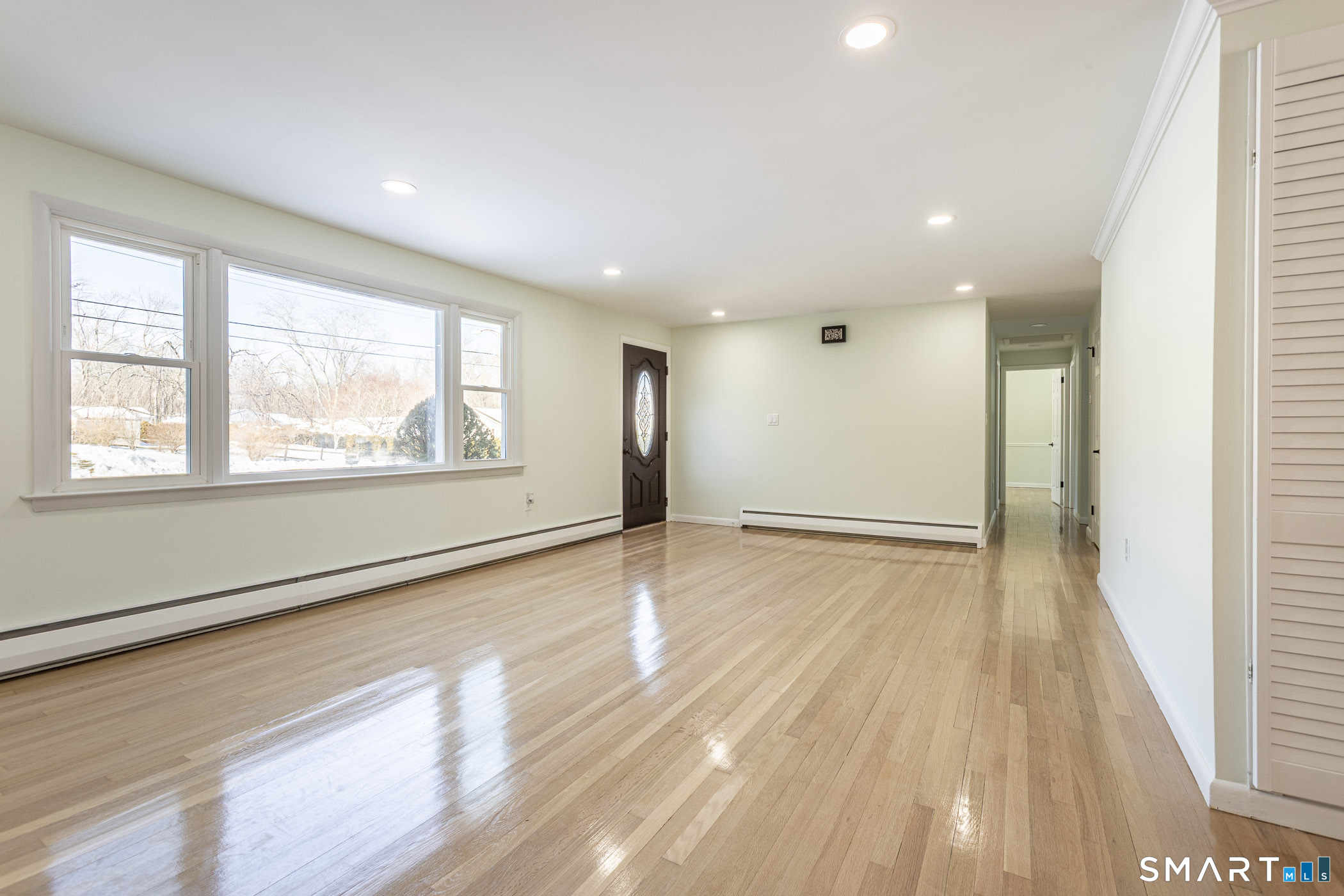 26 Kelly Road Hamden, CT 06518 - Photo 9 of 37 a view of an empty room with wooden floor and a window