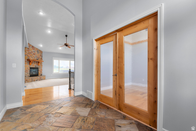 1501 West Elk Circle Mapleton, UT 84664 - Photo 12 of 39 Entryway featuring natural stone tile flooring and light wood double doors with frosted glass panels