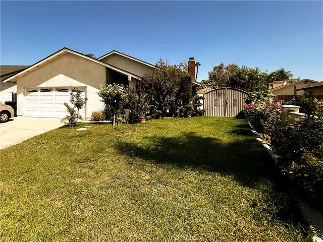 a view of a street with a view of a house with a yard
