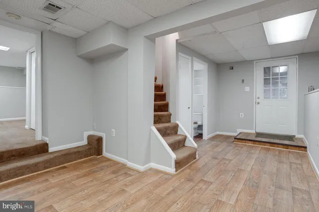 a view of a room with wooden floor and white walls