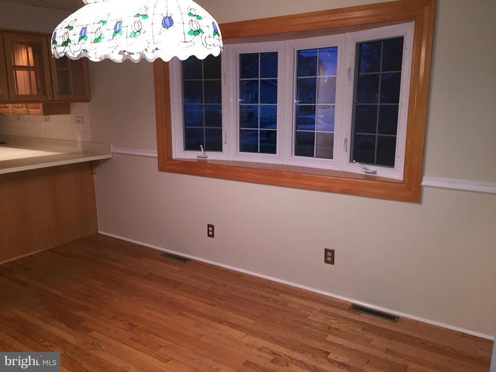 1206 3rd Road Middle River, MD 21220 - Photo 8 of 19 a view of a room that has wooden floor and large windows