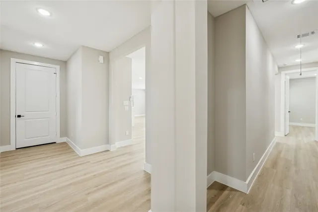 a view of hallway with wooden floor