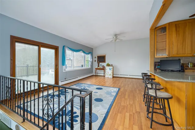 a view of a room with wooden floor