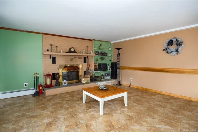 a room with a black white checkered floor with a gaming machine and a rug