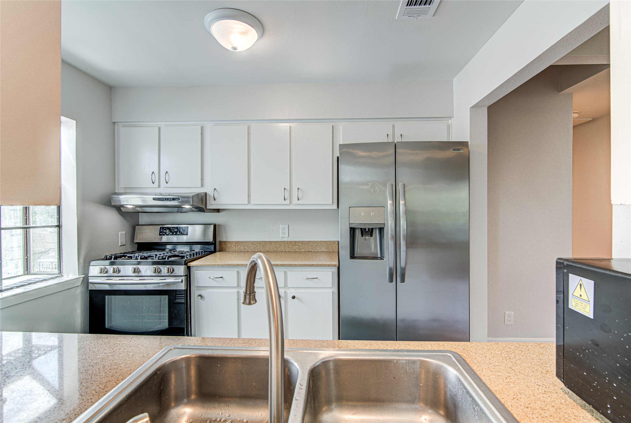 311 West Mary Street Austin, TX 78704 - Photo 15 of 35 Functional kitchen with ample cabinet storage and modern stainless steel appliances.