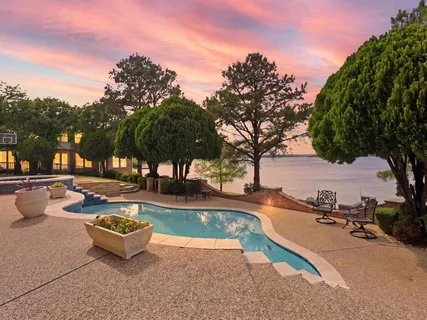 a view of a lake with a house in a yard