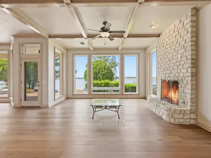 a view of a livingroom with furniture wooden floor and a window