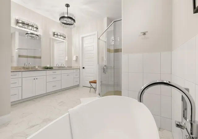 a dining room with wooden floor a chandelier a wooden table and chairs