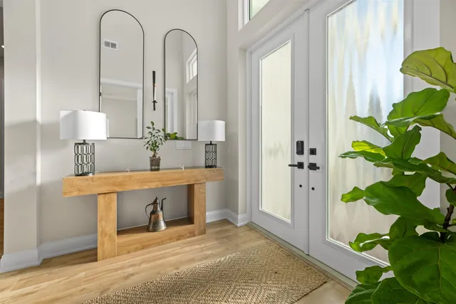 a view of a hallway view with wooden floor and furniture