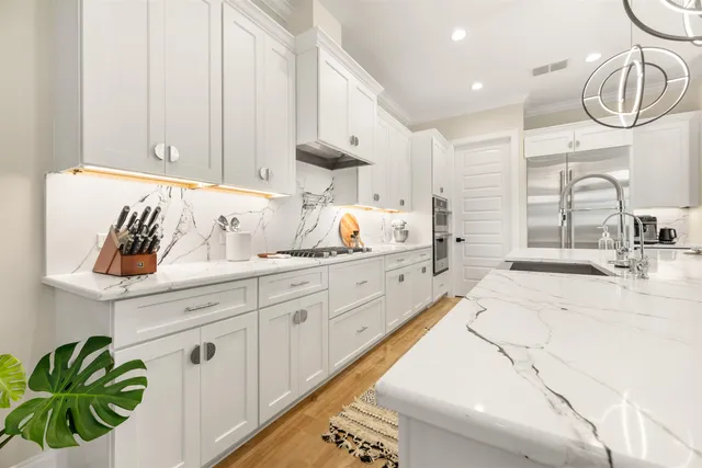 a view of hallway with a large window and wooden floor