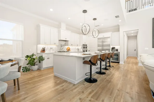 a bedroom with two beds and a chandelier