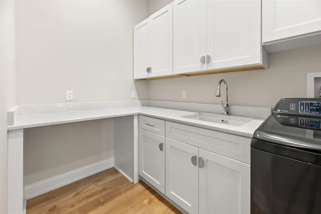 a living room with furniture a flat screen tv and a floor to ceiling window