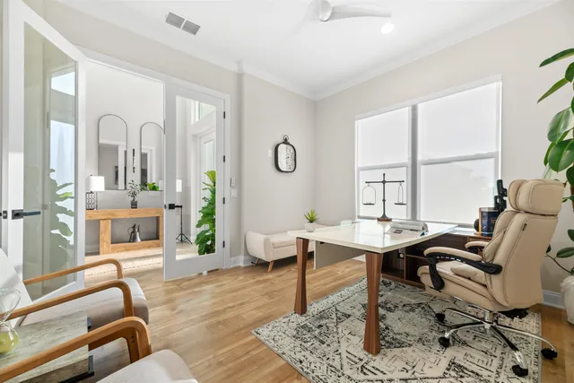 a living room with furniture and a floor to ceiling window
