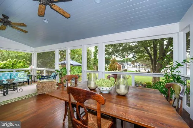 a living room with patio furniture and a potted plant