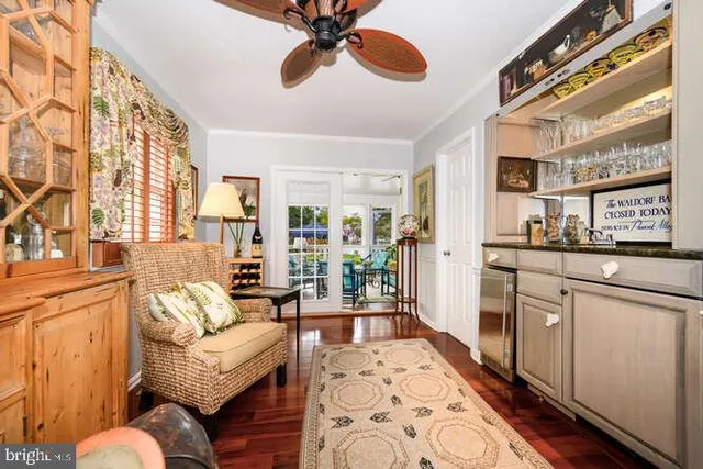 a living room with furniture a chandelier and a rug