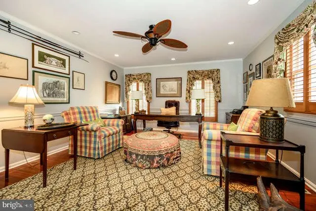 a view of a bedroom with furniture and windows