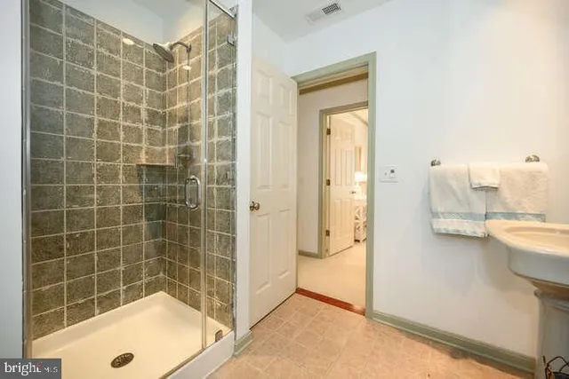 a living room with furniture a wooden floor and next to a window