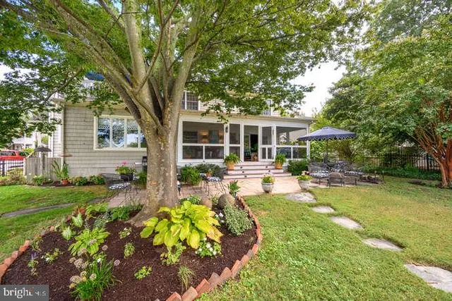 a view of a lake with a chairs and table on the terrace