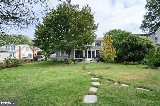 a view of a house with backyard and sitting area