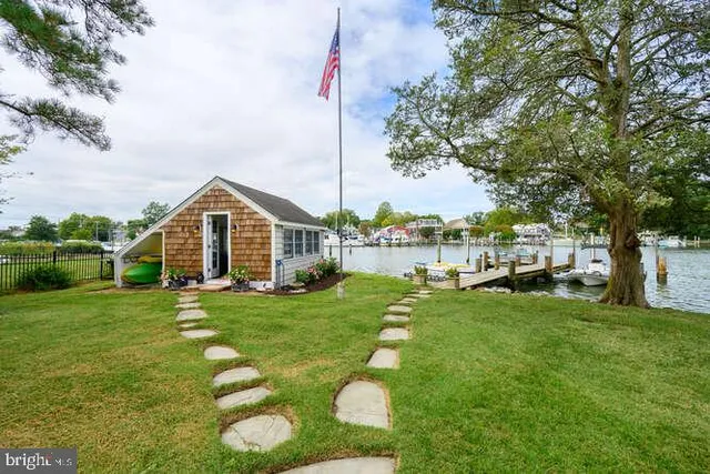 a view of a house with a backyard porch and sitting area