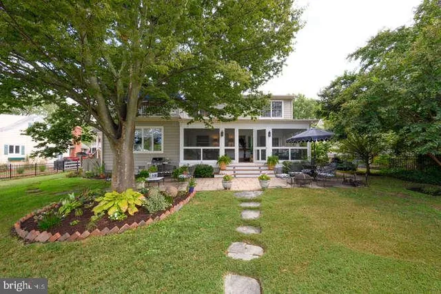 a view of a house with swimming pool and porch with furniture