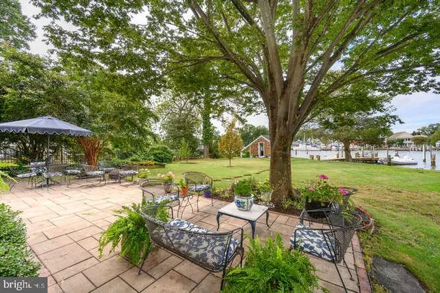 a view of a swimming pool and lounge chairs in back yard
