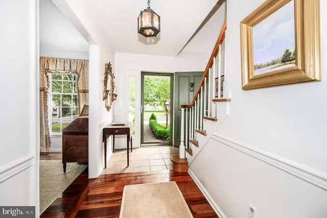 a view of an entryway with wooden floor and windows