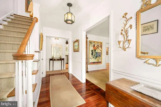 a view of an entryway with wooden floor and door
