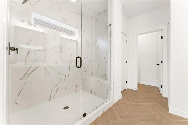 a bathroom with a bathtub and shower