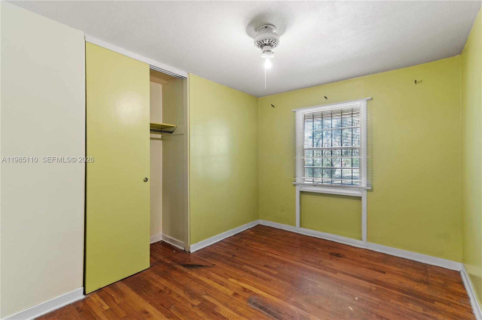 115 Southwest Lee Avenue Madison, FL 32340 - Photo 11 of 17 a view of empty room with wooden floor and fan