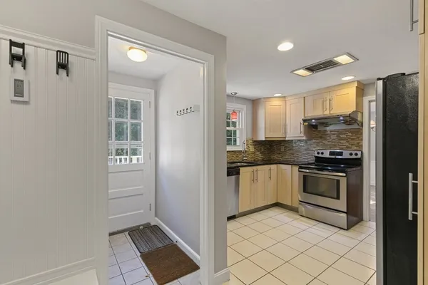 a kitchen with a refrigerator and a stove top oven